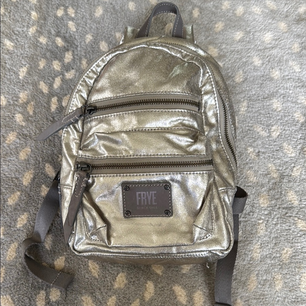 Frye backpack purse in silver. Dimensions pictured. Very clean and barely used